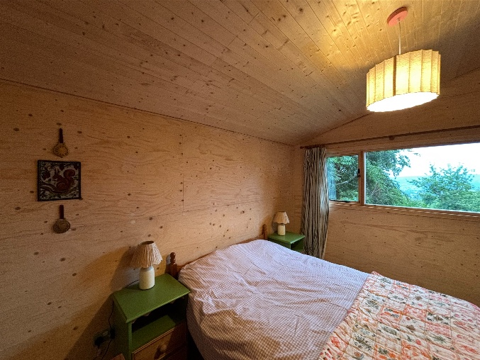 The cabin double bedroom with timber walls